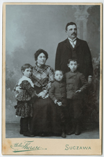 Studio portrait photograph of the Guttman family.